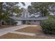 Ranch style home with attached garage and mature landscaping at 1566 Long St, Clearwater, FL 33755