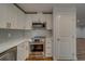 Updated kitchen with stainless steel appliances and white cabinets at 1566 Long St, Clearwater, FL 33755