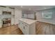 Modern kitchen with white cabinets, quartz countertops, and stainless steel appliances at 1566 Long St, Clearwater, FL 33755