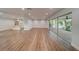 Expansive living room with hardwood floors and access to a patio at 1566 Long St, Clearwater, FL 33755