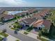 Aerial view of house and neighborhood with lake at 16931 Scuba Crest St, Wimauma, FL 33598