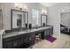 Double vanity bathroom with granite countertop and mirrors at 16931 Scuba Crest St, Wimauma, FL 33598