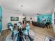 Open concept dining area with glass table and chairs near the kitchen and living room at 16931 Scuba Crest St, Wimauma, FL 33598