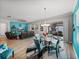 Open concept dining area with glass table and chairs near living room and kitchen at 16931 Scuba Crest St, Wimauma, FL 33598