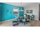 Bright dining room with glass table and comfortable seating for four at 16931 Scuba Crest St, Wimauma, FL 33598