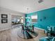 Dining area with glass table and chairs, and access to backyard patio at 16931 Scuba Crest St, Wimauma, FL 33598