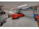 Spacious garage with overhead storage and ample room for vehicles and workshop at 16931 Scuba Crest St, Wimauma, FL 33598