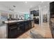 Island kitchen features granite countertops and dark wood cabinets at 16931 Scuba Crest St, Wimauma, FL 33598