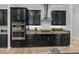 Modern kitchen with dark wood cabinets and granite countertops at 16931 Scuba Crest St, Wimauma, FL 33598