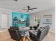 Relaxing living room with leather furniture and a large TV at 16931 Scuba Crest St, Wimauma, FL 33598