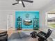 Relaxing living room with comfortable seating and a stylish accent wall at 16931 Scuba Crest St, Wimauma, FL 33598