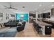 Open living area with leather furniture and wood-look tile floors at 16931 Scuba Crest St, Wimauma, FL 33598