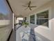 Peaceful screened porch with ceiling fan, potted plants and rug at 16931 Scuba Crest St, Wimauma, FL 33598