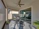 Cozy screened porch with glass doors, seating area and ceiling fan at 16931 Scuba Crest St, Wimauma, FL 33598
