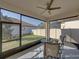 Screened porch with seating area, ceiling fan and view of backyard at 16931 Scuba Crest St, Wimauma, FL 33598