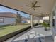 Screened porch with ceiling fan, and backyard view at 16931 Scuba Crest St, Wimauma, FL 33598
