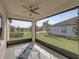 Spacious screened porch with ceiling fan, offering a tranquil outdoor space at 16931 Scuba Crest St, Wimauma, FL 33598