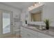 Bathroom with granite countertop, white cabinets and walk in shower at 1811 Stonebrook Ln, Safety Harbor, FL 34695