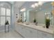 Elegant bathroom with double vanity, large mirror, and plantation shutters at 1811 Stonebrook Ln, Safety Harbor, FL 34695