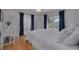 Bright bedroom with a queen-size bed, wood floors, and access to the pool at 1811 Stonebrook Ln, Safety Harbor, FL 34695
