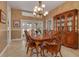 Formal dining room with wood table and chairs, and elegant chandelier at 1811 Stonebrook Ln, Safety Harbor, FL 34695