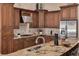 Large kitchen with stainless steel appliances, granite countertops, and rich wood cabinets at 1811 Stonebrook Ln, Safety Harbor, FL 34695