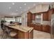 Island kitchen features granite countertops, stainless steel appliances, and breakfast bar at 1811 Stonebrook Ln, Safety Harbor, FL 34695