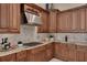 Modern kitchen with granite countertops, stainless steel appliances, and custom cabinetry at 1811 Stonebrook Ln, Safety Harbor, FL 34695