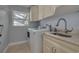 Convenient laundry room with washer, dryer, and granite countertop at 1811 Stonebrook Ln, Safety Harbor, FL 34695