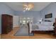 Serene main bedroom with hardwood floors, a ceiling fan and access to the pool area at 1811 Stonebrook Ln, Safety Harbor, FL 34695