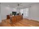Home office with large desk, hardwood floors, and ample natural light at 1811 Stonebrook Ln, Safety Harbor, FL 34695