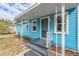 Light blue house with a front porch and landscaped yard at 1841 Overbrook Ave, Clearwater, FL 33755