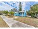 A light blue house on a tree-lined street with a sidewalk at 1841 Overbrook Ave, Clearwater, FL 33755