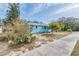 Light blue house with a walkway, and mature landscaping at 1841 Overbrook Ave, Clearwater, FL 33755