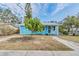 Charming light blue house with a manicured lawn and walkway at 1841 Overbrook Ave, Clearwater, FL 33755