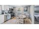 Eat-in kitchen with white cabinets, stainless steel appliances and a round table at 1841 Overbrook Ave, Clearwater, FL 33755
