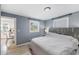 Main bedroom with king-size bed and view into the kitchen at 1841 Overbrook Ave, Clearwater, FL 33755