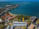 Aerial view of waterfront condo building with parking and lush landscaping at 2700 Bayshore Blvd # 6308, Dunedin, FL 34698