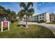 Condo building with palm trees and parking lot at 2700 Bayshore Blvd # 6308, Dunedin, FL 34698