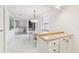 White kitchen with tile counters and appliances at 2700 Bayshore Blvd # 6308, Dunedin, FL 34698