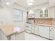 White kitchen features tile counters and cabinets at 2700 Bayshore Blvd # 6308, Dunedin, FL 34698
