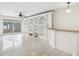 Spacious living room with built-in shelving and tile floors at 2700 Bayshore Blvd # 6308, Dunedin, FL 34698