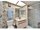 Bathroom with shower, toilet, and tropical-themed wallpaper at 2913 Aston Ave, Plant City, FL 33566
