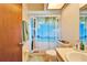 Bathroom with beach-themed shower curtain and updated vanity at 2913 Aston Ave, Plant City, FL 33566