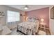 Cozy bedroom with floral bedding and a ceiling fan at 2913 Aston Ave, Plant City, FL 33566