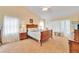 Spacious bedroom with a wooden bed frame and carpet flooring at 2913 Aston Ave, Plant City, FL 33566