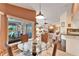 Breakfast nook with glass table and wicker chairs, views of living room and pool at 2913 Aston Ave, Plant City, FL 33566