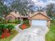 Landscaped yard with brick driveway leading to a house at 2913 Aston Ave, Plant City, FL 33566