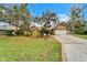 Tan brick house with lush landscaping and a two-car garage at 2913 Aston Ave, Plant City, FL 33566