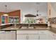 Kitchen with granite countertops and stainless steel sink, open to Gathering room at 2913 Aston Ave, Plant City, FL 33566